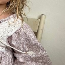 Load image into Gallery viewer, girl wearing a floral top with a plain background