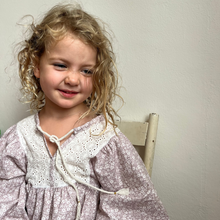 Load image into Gallery viewer, Young girl with wearing a floral top against a plain background