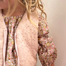 Load image into Gallery viewer, girl wearing a floral blouse with a plain background