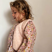 Load image into Gallery viewer, Young girl wearing a floral top with a plain background
