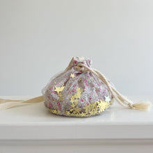 Load image into Gallery viewer, Floral drawstring bag with gold stars on a white surface