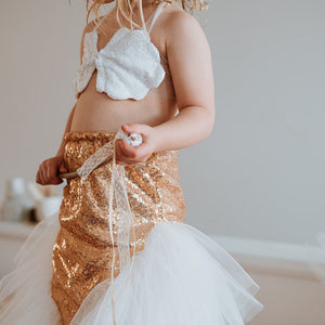 Child wearing a gold sequin dress 