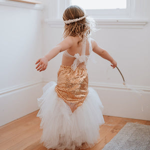 Child in a gold sequin mermaid dress 
